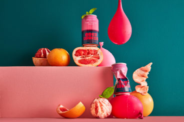 toronto-non-alcoholic-drinks-geez-louise Cans of Geez Louise are surrounded by peeled grapefruits, mint leaves and water balloons