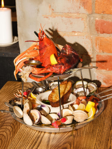 toronto-restaurants-st-johns-tavern-entertainment-district-tower A seafood tower with a pound of poached lobster, crab legs, poached black tiger shrimp, eight oysters, eight clams, snow crab claws, a mussel escabeche with toasted garlic focaccia and all the necessary fixings: mignonette, horseradish, melted butter and lemon wedges