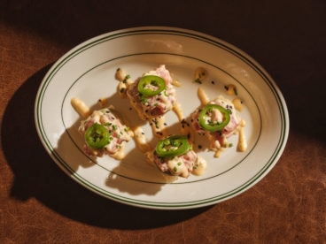 toronto-restaurants-st-johns-tavern-entertainment-district-tuna-tartare Four stacks of ahi tuna and crispy rice topped with avocado crema, lime juice, mayo, sriracha, toasted jalapeño and black sesame seeds